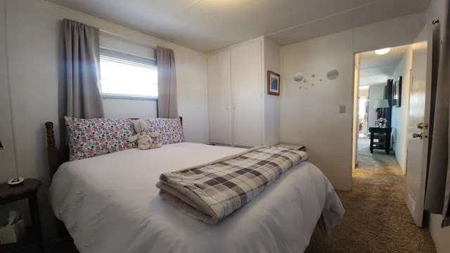 a bedroom with a bed and a window