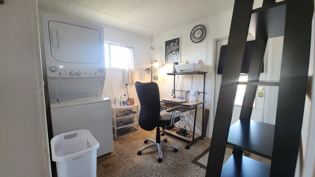 a view of a balcony with chairs and wooden floor