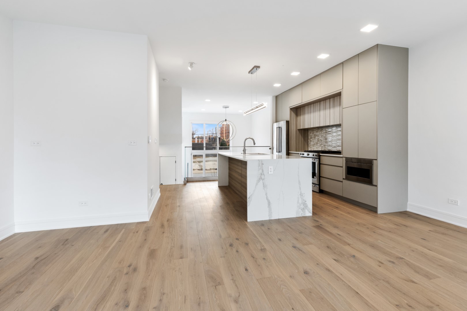 338 East Pershing Road Chicago, IL 60653 - Photo 19 of 86 a view of kitchen with kitchen island wooden floors and stainless steel appliances