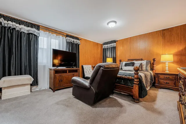 a bedroom with a bed and a flat screen television