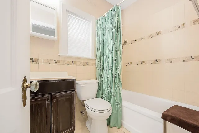 a bathroom with a toilet a sink and bathtub
