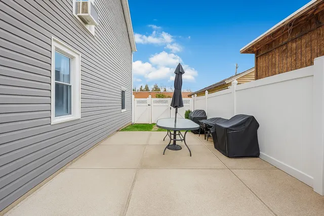 a roof deck with table and chairs