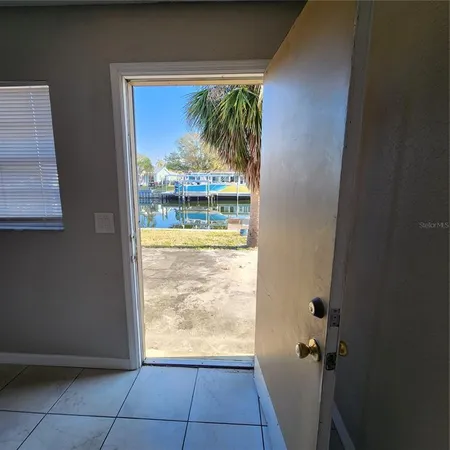 a view of entryway with a palm tree