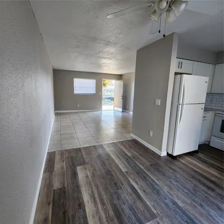 a kitchen with a white stove top oven and refrigerator