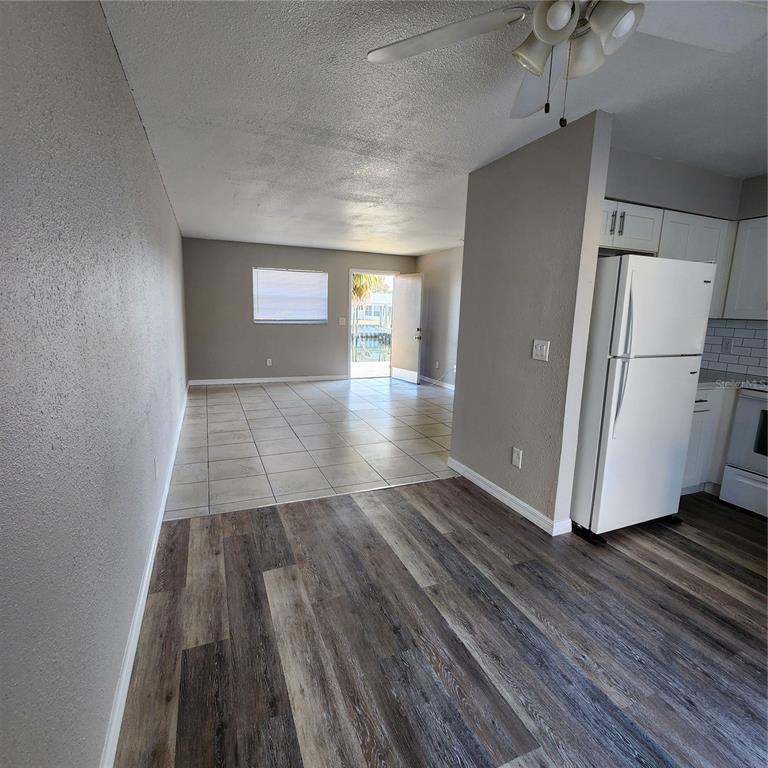 1037 Apollo Beach Boulevard, Unit D Apollo Beach, FL 33572 - Photo 16 of 42 a view of a room with wooden floor and a refrigerator