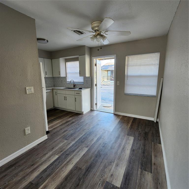 1037 Apollo Beach Boulevard, Unit D Apollo Beach, FL 33572 - Photo 18 of 42 wooden floor in an empty room with a kitchen