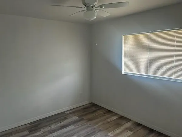 a large kitchen with a sink refrigerator and microwave