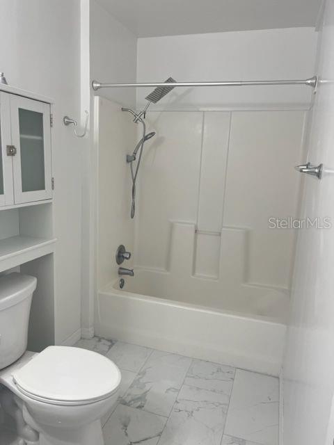 1037 Apollo Beach Boulevard, Unit D Apollo Beach, FL 33572 - Photo 37 of 42 a white toilet sitting next to a bath tub and a shower