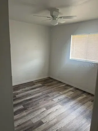 a utility room with wooden floor washer and dryer