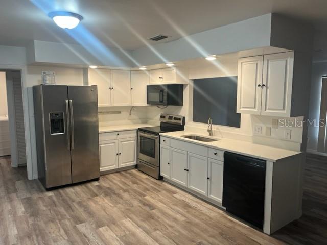 1037 Apollo Beach Boulevard, Unit D Apollo Beach, FL 33572 - Photo 40 of 42 a kitchen with a sink stainless steel appliances and white cabinets