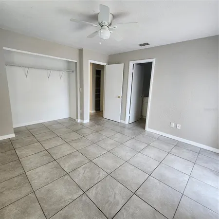 a view of a livingroom with closet and chandelier fan