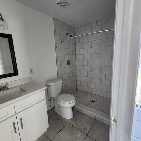 a bathroom with a shower toilet and sink