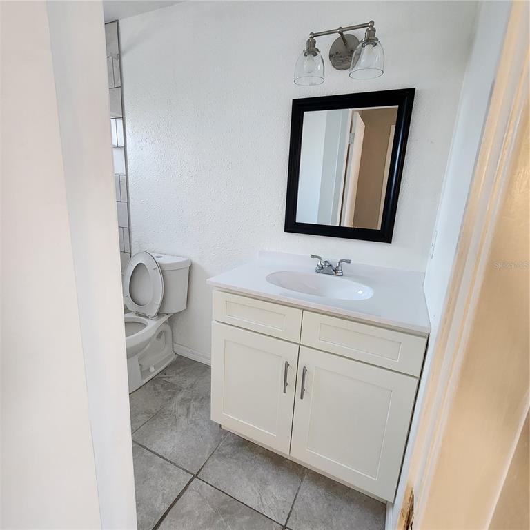 1037 Apollo Beach Boulevard, Unit D Apollo Beach, FL 33572 - Photo 9 of 42 a bathroom with a toilet sink vanity and mirror