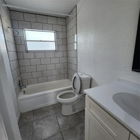 a bathroom with a sink a toilet and bathtub