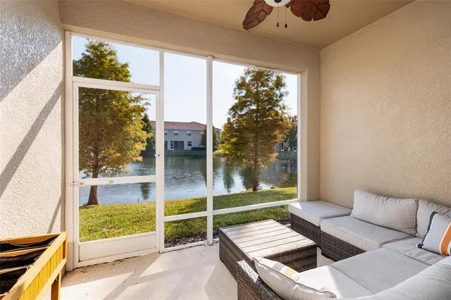 a living room with furniture and a floor to ceiling window