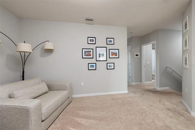 a living room with furniture and a lamp