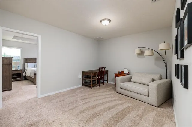 a bedroom with a bed and a refrigerator