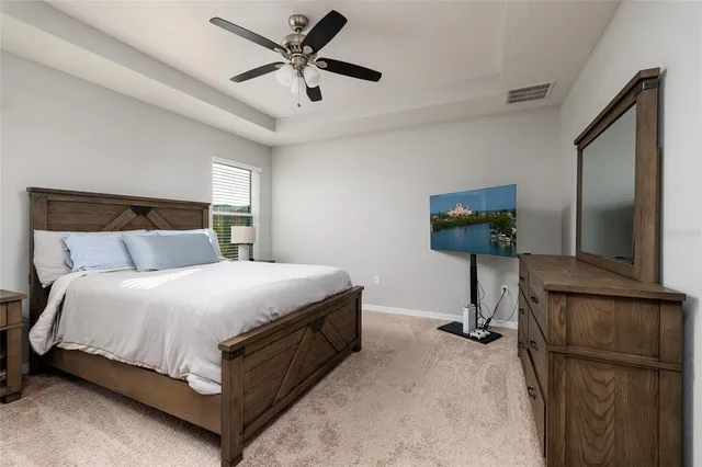 a spacious bathroom with a granite countertop sink a mirror and a shower