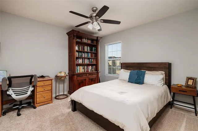 a bathroom with a granite countertop sink a toilet and a mirror