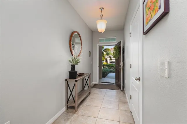 a view of a room with wooden floor mirror and windows
