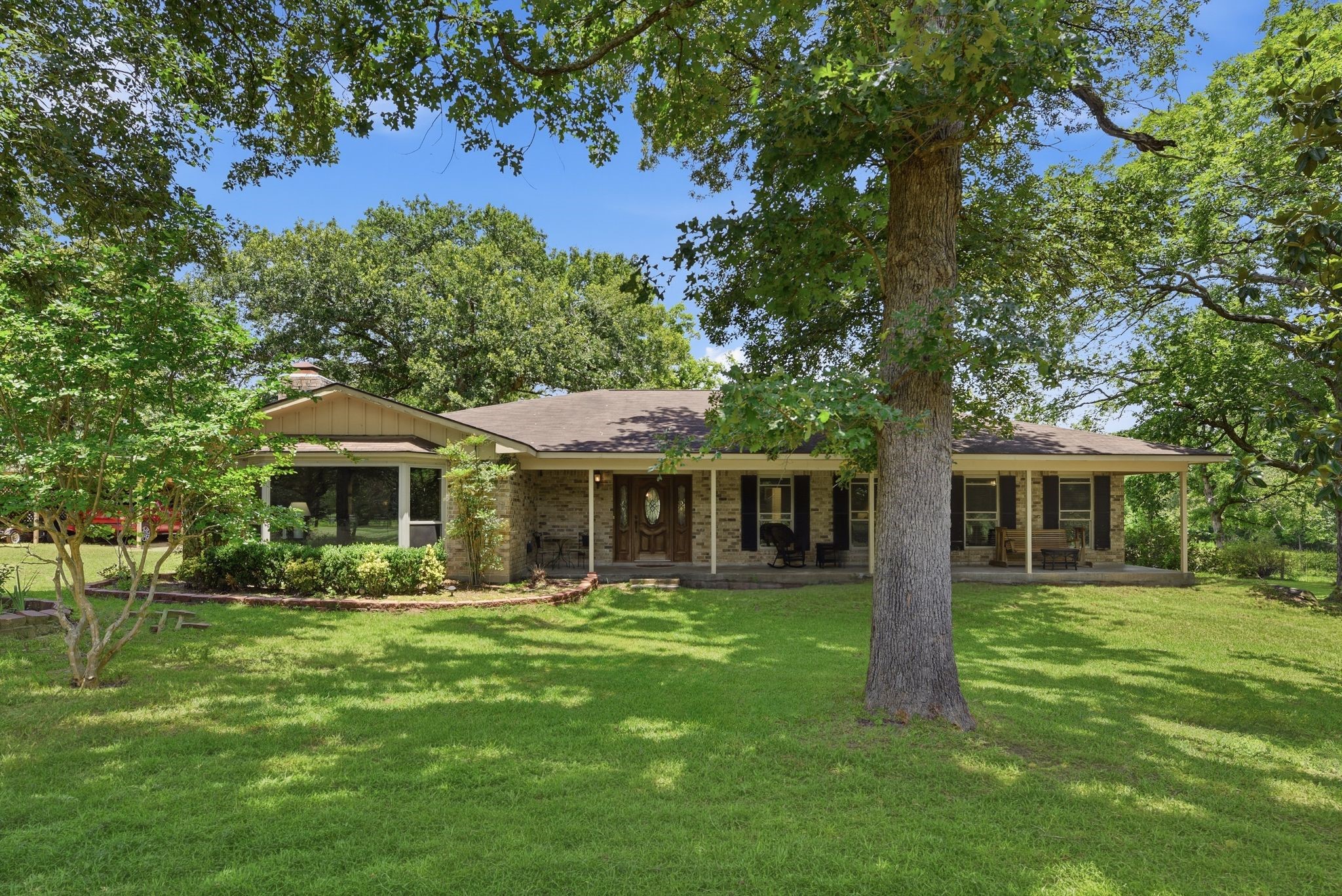 280 McGehee Road Willis, TX 77378 - Photo 1 of 50 Charming single-story home nestled in a lush, green setting with mature trees and spacious front yard. Features a welcoming front porch and classic exterior, perfect for enjoying peaceful outdoor moments.