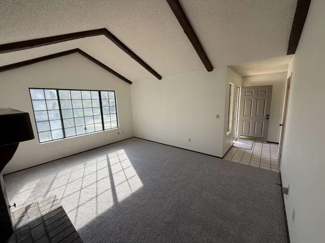 a kitchen with granite countertop a stove top oven a sink dishwasher and a fireplace with wooden floor