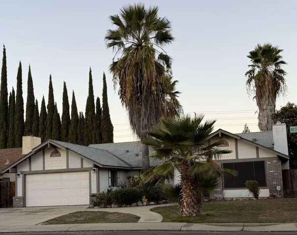 a view of a house with a palm tree