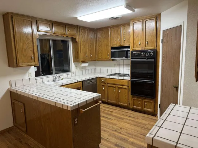 a kitchen with a sink stove and refrigerator