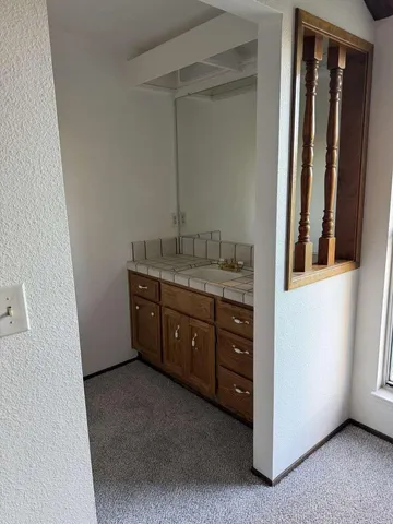 a spacious bathroom with a granite countertop sink and a mirror