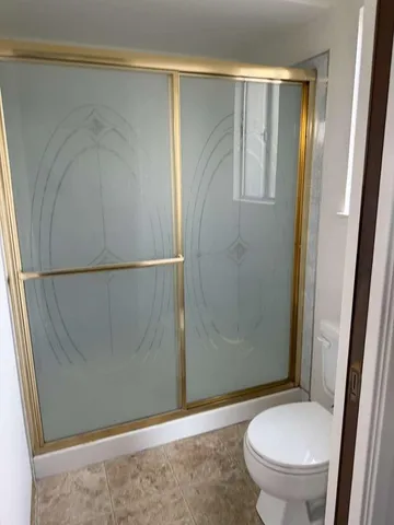 a bathroom with a toilet and a shower