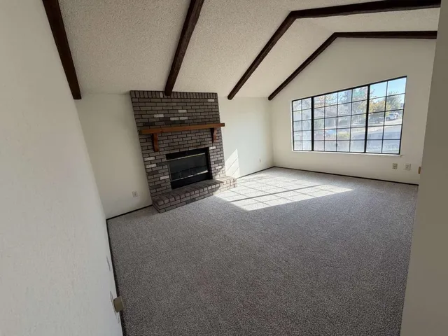 a view of an empty room with a fireplace