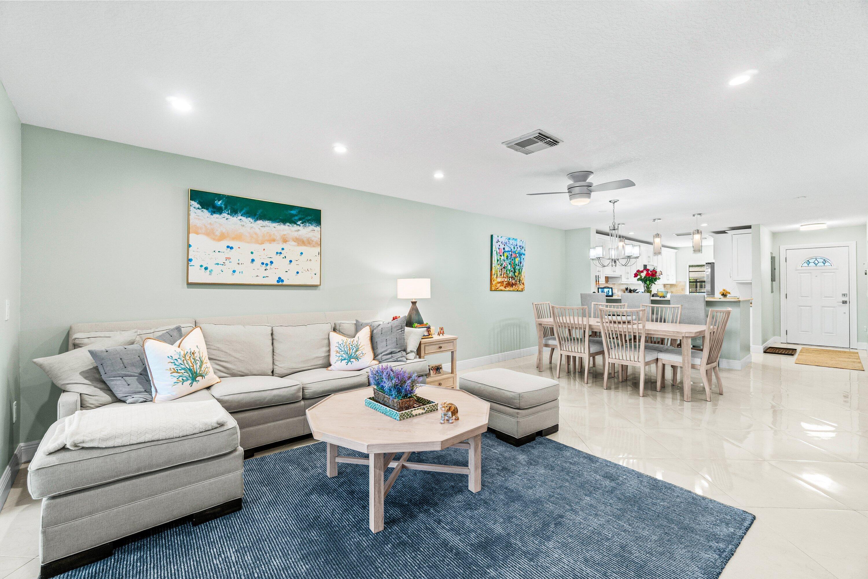 24 Stratford Drive East, Unit D Boynton Beach, FL 33436 - Photo 13 of 52 a living room with furniture and a table