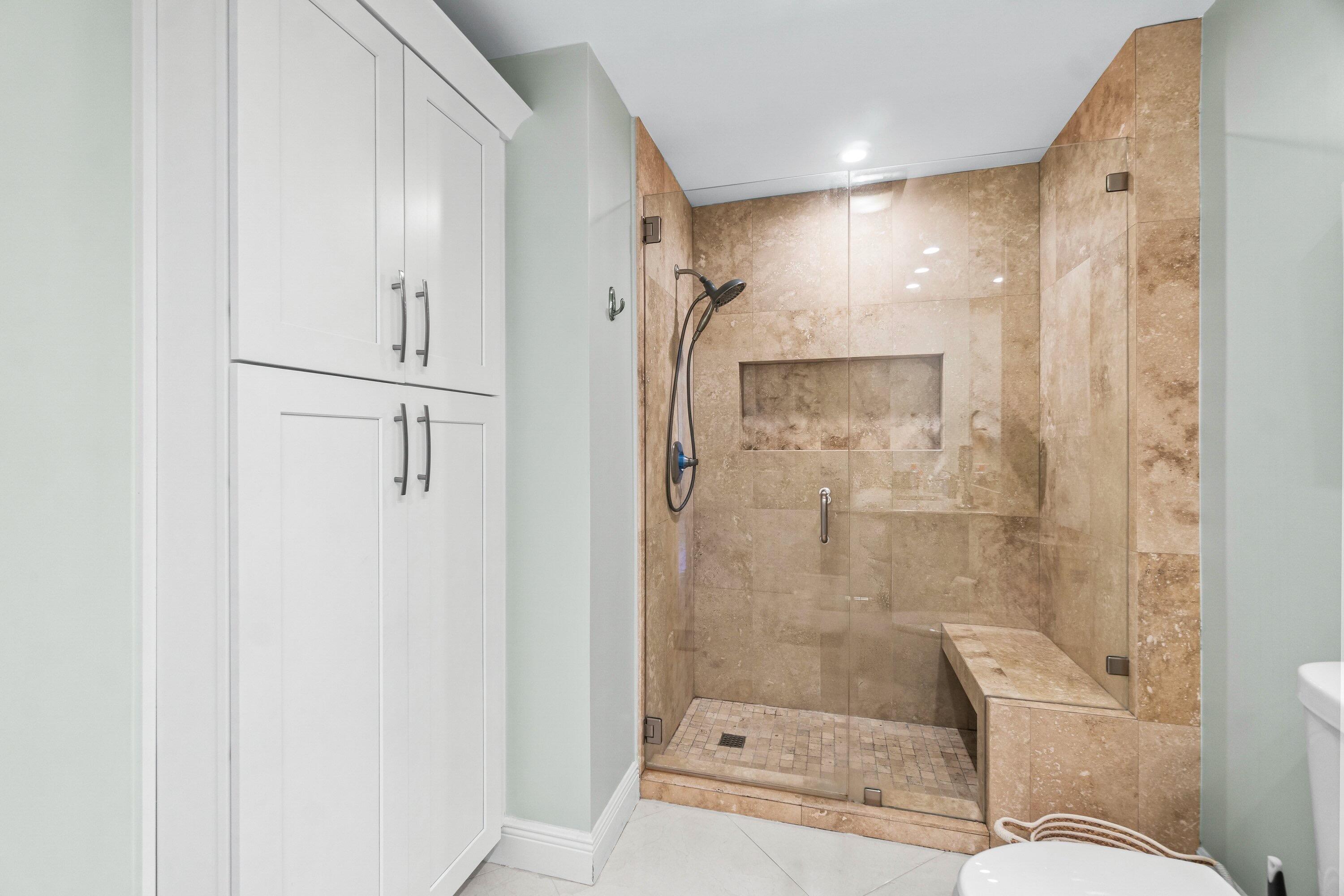 24 Stratford Drive East, Unit D Boynton Beach, FL 33436 - Photo 21 of 52 a bathroom with a shower a toilet and sink