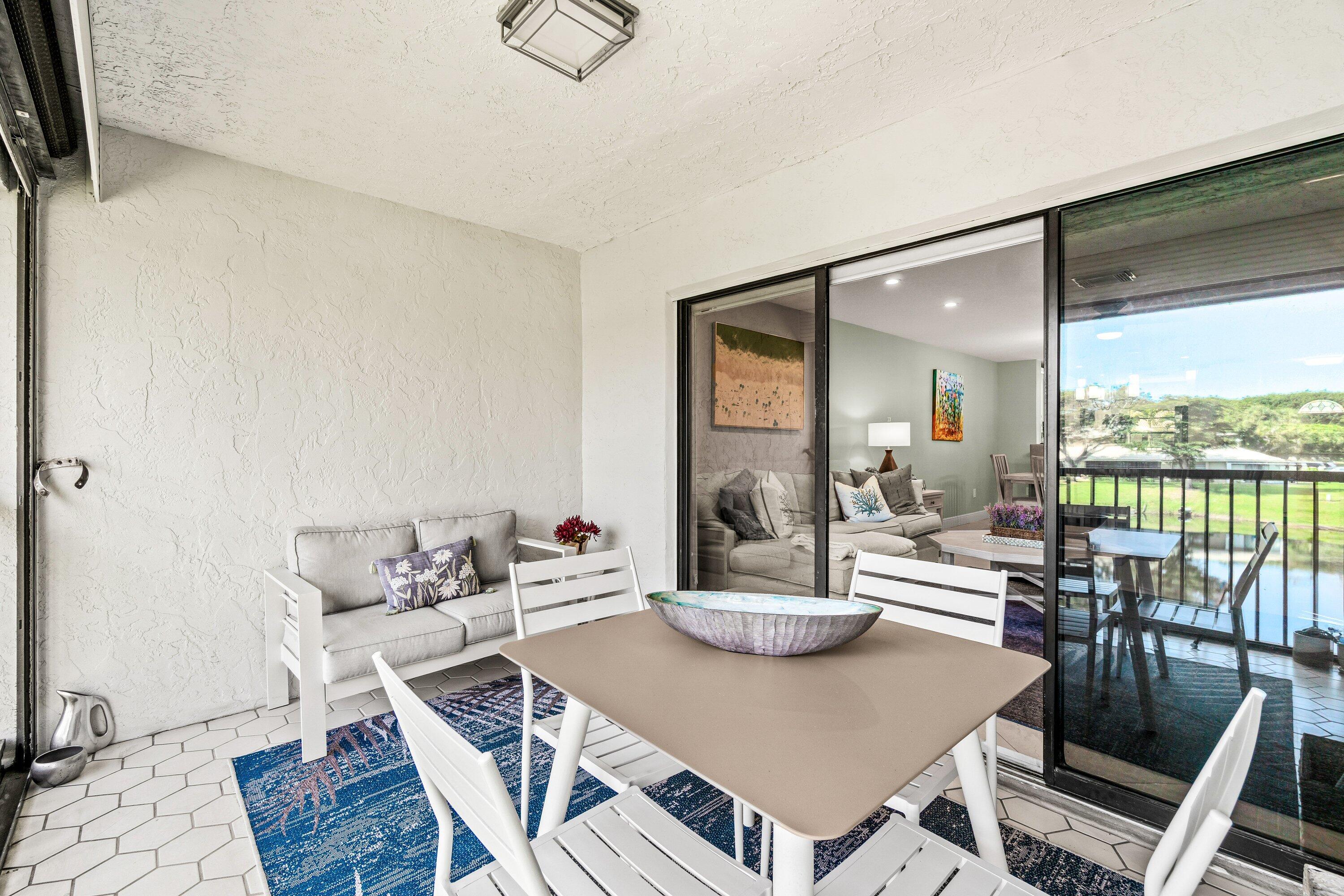 24 Stratford Drive East, Unit D Boynton Beach, FL 33436 - Photo 26 of 52 a view of a dining room with furniture wooden floor and a potted plant