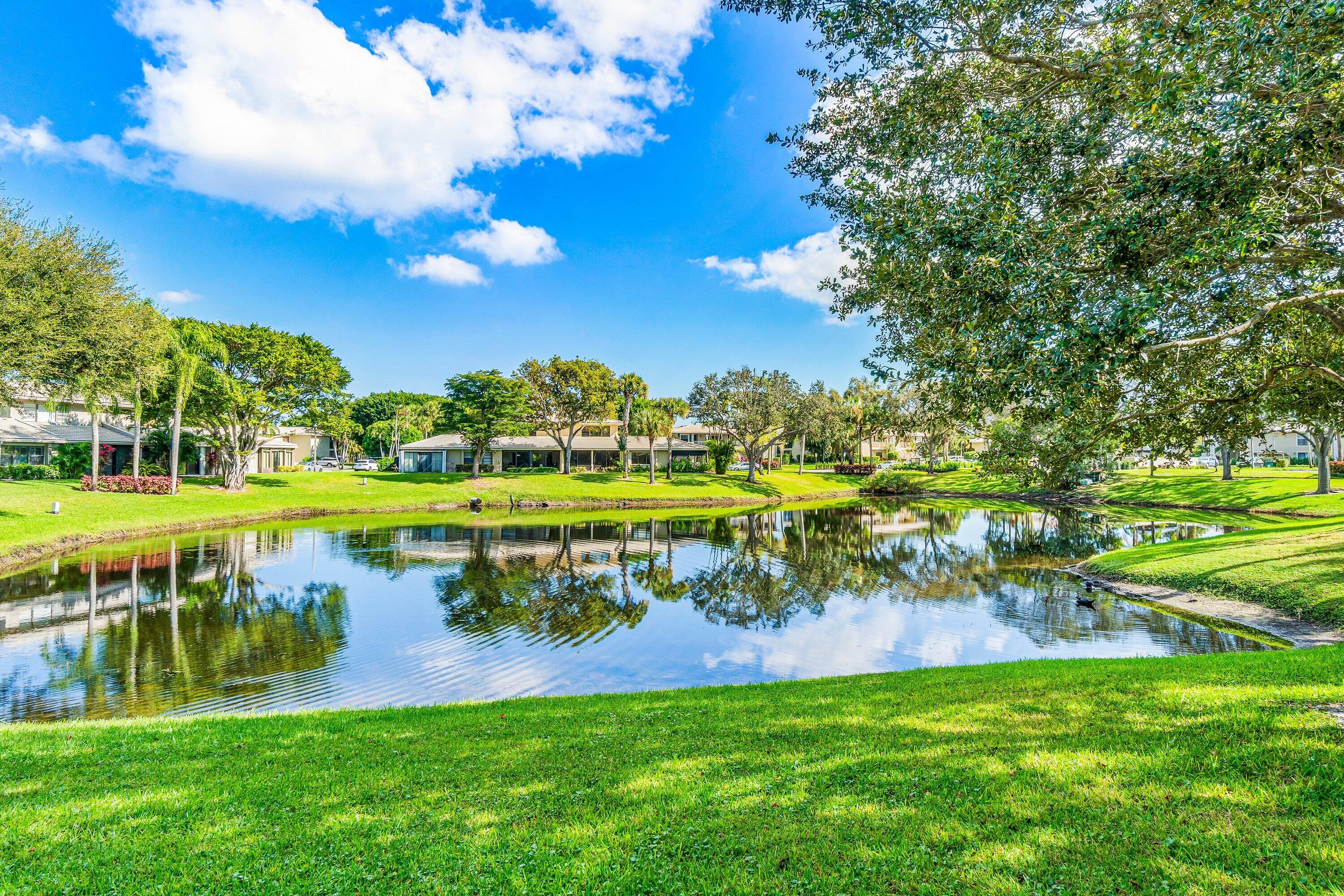 24 Stratford Drive East, Unit D Boynton Beach, FL 33436 - Photo 30 of 52 a view of a golf course with a lake