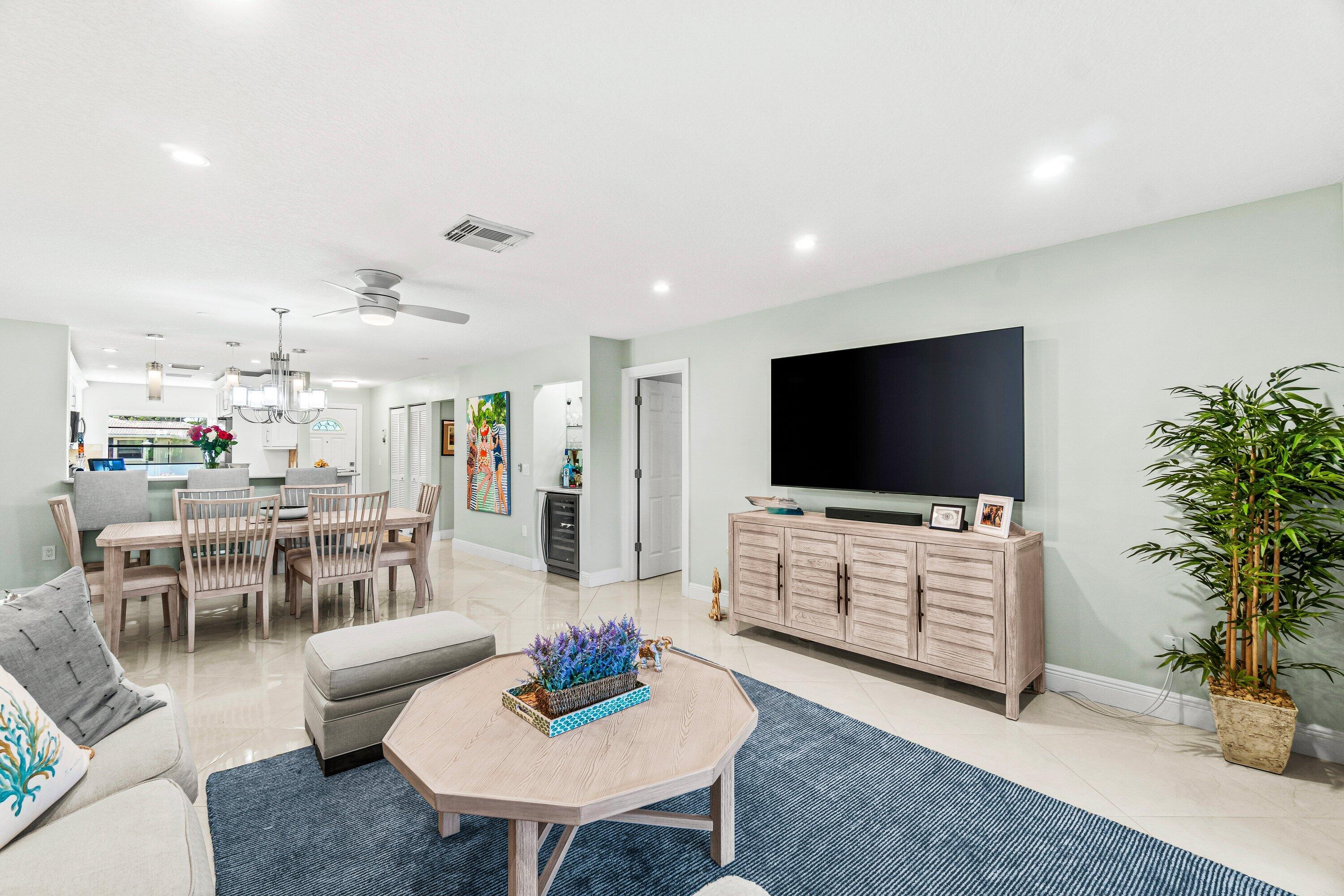 24 Stratford Drive East, Unit D Boynton Beach, FL 33436 - Photo 4 of 52 a living room with furniture and a flat screen tv