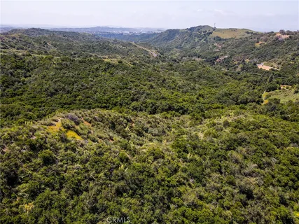 a view of a field with a mountain in the background
