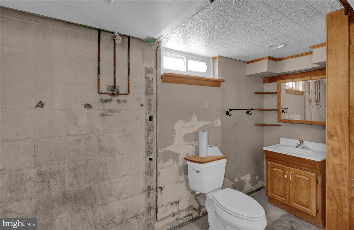 27 Woodland Road Reading, PA 19610 - Photo 23 of 34 a white toilet sitting next to a bathroom sink and a shower