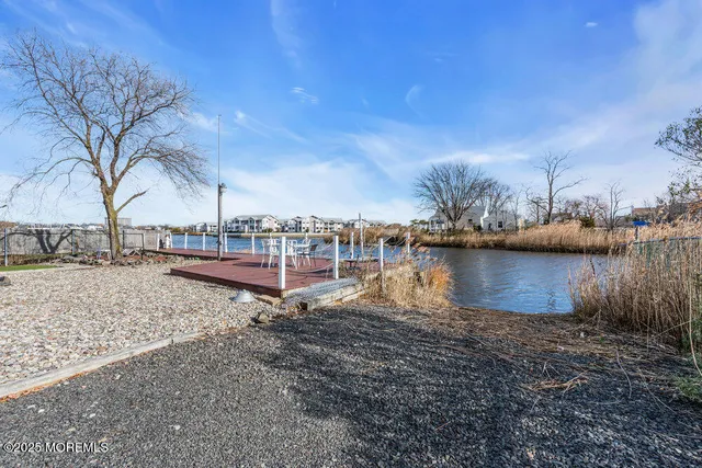 a living room with furniture flat screen tv and wooden floor