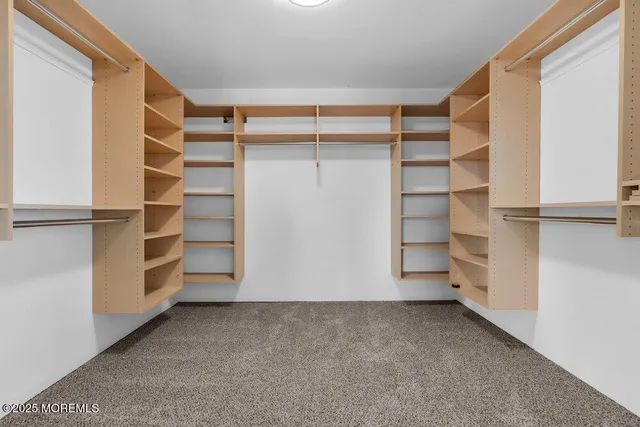 a bedroom with a bed and painting on the wall