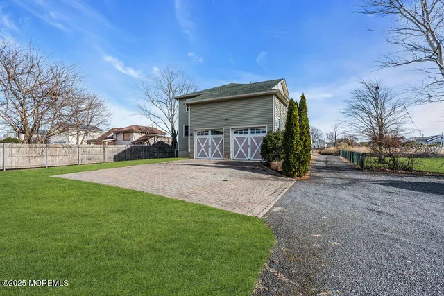 a view of a patio with wooden floor next to a yard