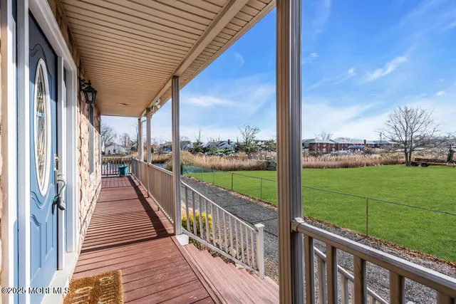 a view of a balcony with wooden floor