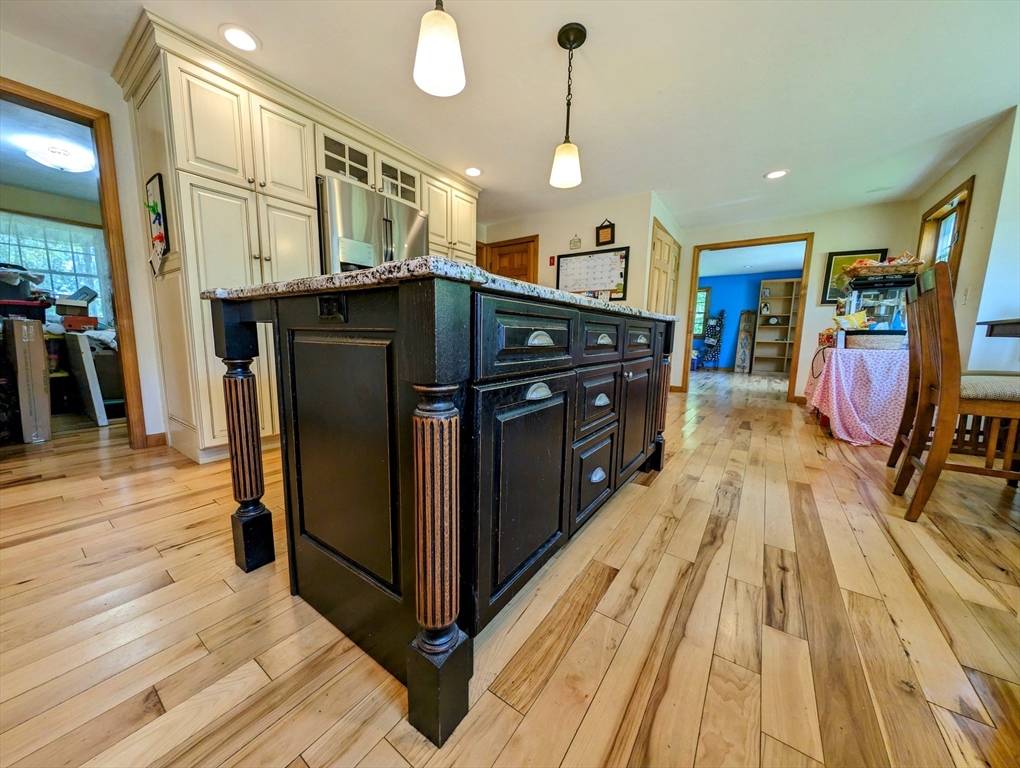7 Robbins Road Charlton, MA 01507 - Photo 20 of 28 a kitchen with stainless steel appliances granite countertop a refrigerator a stove and a wooden floors