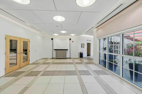 a view of empty room with wooden floor and door