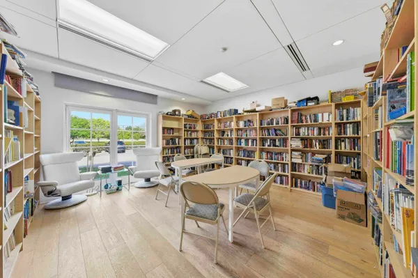 a view of a dining room with furniture and a book shelf