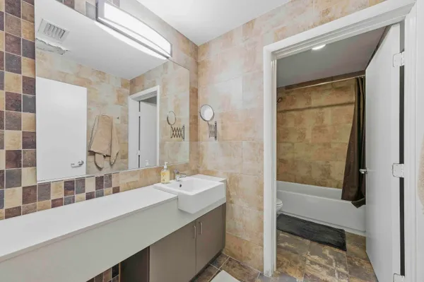 a bathroom with a double vanity sink and mirror