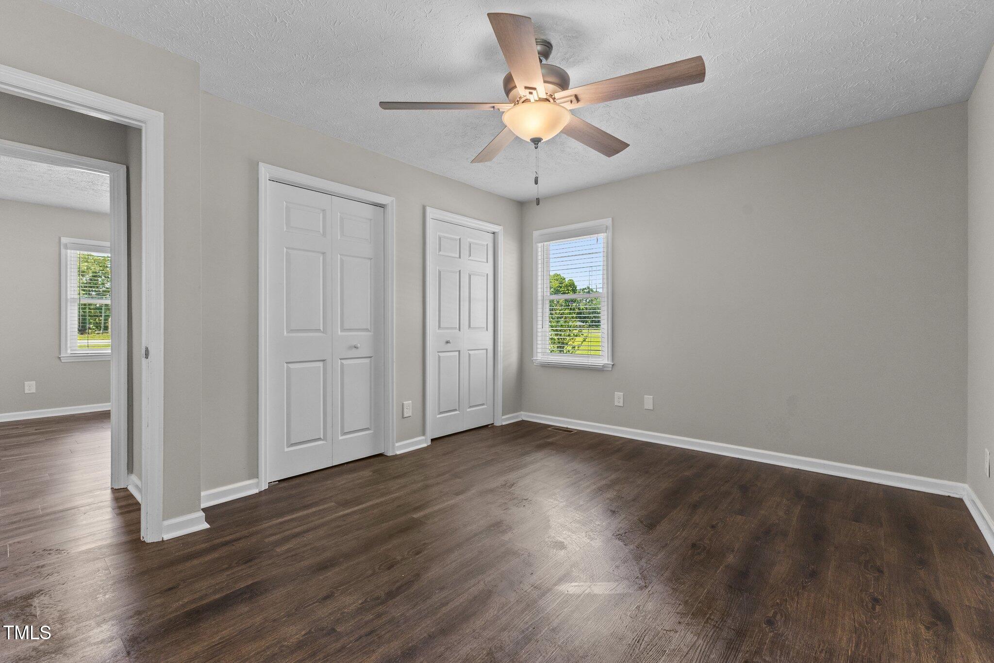 8431 Clinton Road Stedman, NC 28391 - Photo 10 of 24 an empty room with wooden floor and windows