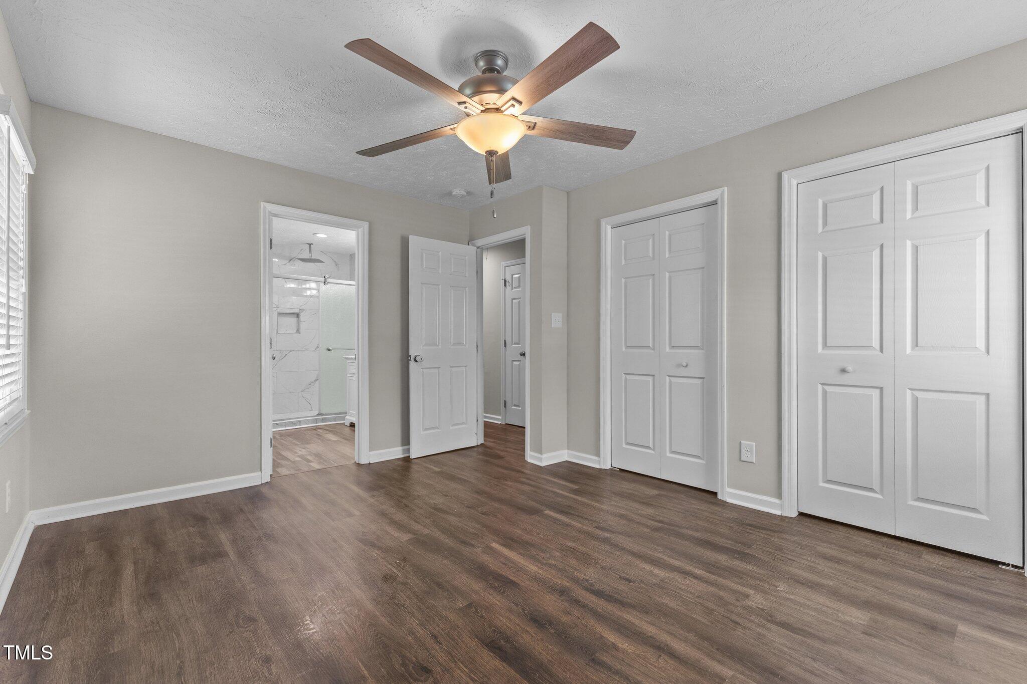 8431 Clinton Road Stedman, NC 28391 - Photo 11 of 24 an empty room with wooden floor and ceiling fan