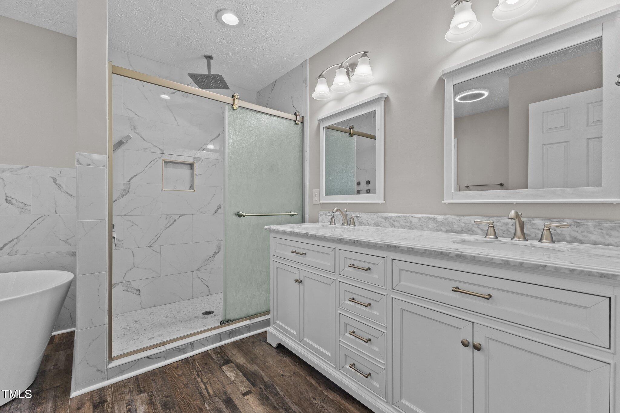 8431 Clinton Road Stedman, NC 28391 - Photo 13 of 24 a bathroom with a shower sink and mirror