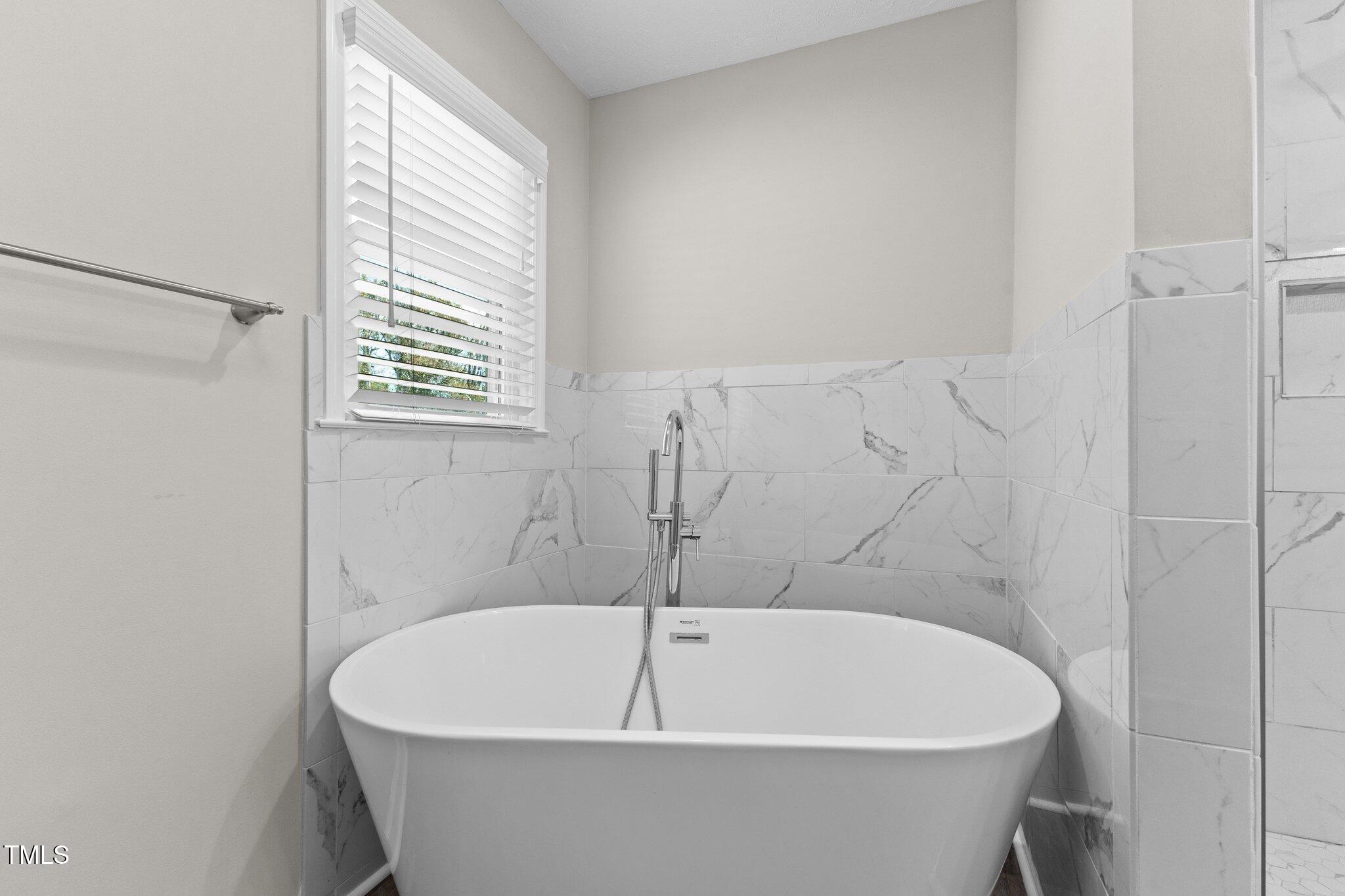 8431 Clinton Road Stedman, NC 28391 - Photo 14 of 24 a white bath tub sitting in a bathroom